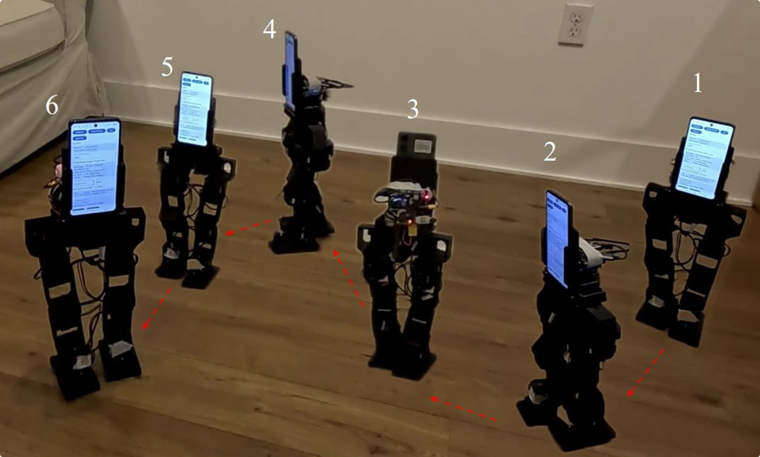 Six PhoneBot robots on a wooden floor, each with an Android phone mounted on its torso